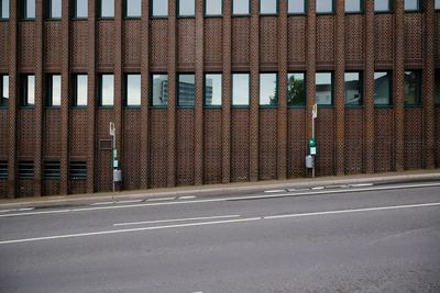 Empty road by building in city