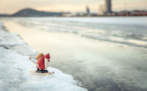 Figurine of santa claus on snow