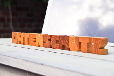 Close-up of wooden text on table