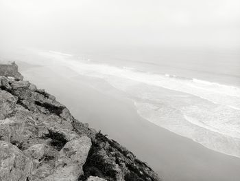 Scenic view of sea and mountains against sky