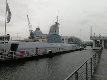 View of harbor against cloudy sky