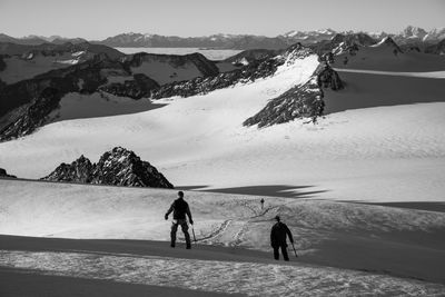 People skiing on snowcapped mountain