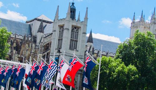 Low angle view of flags against buildings in city