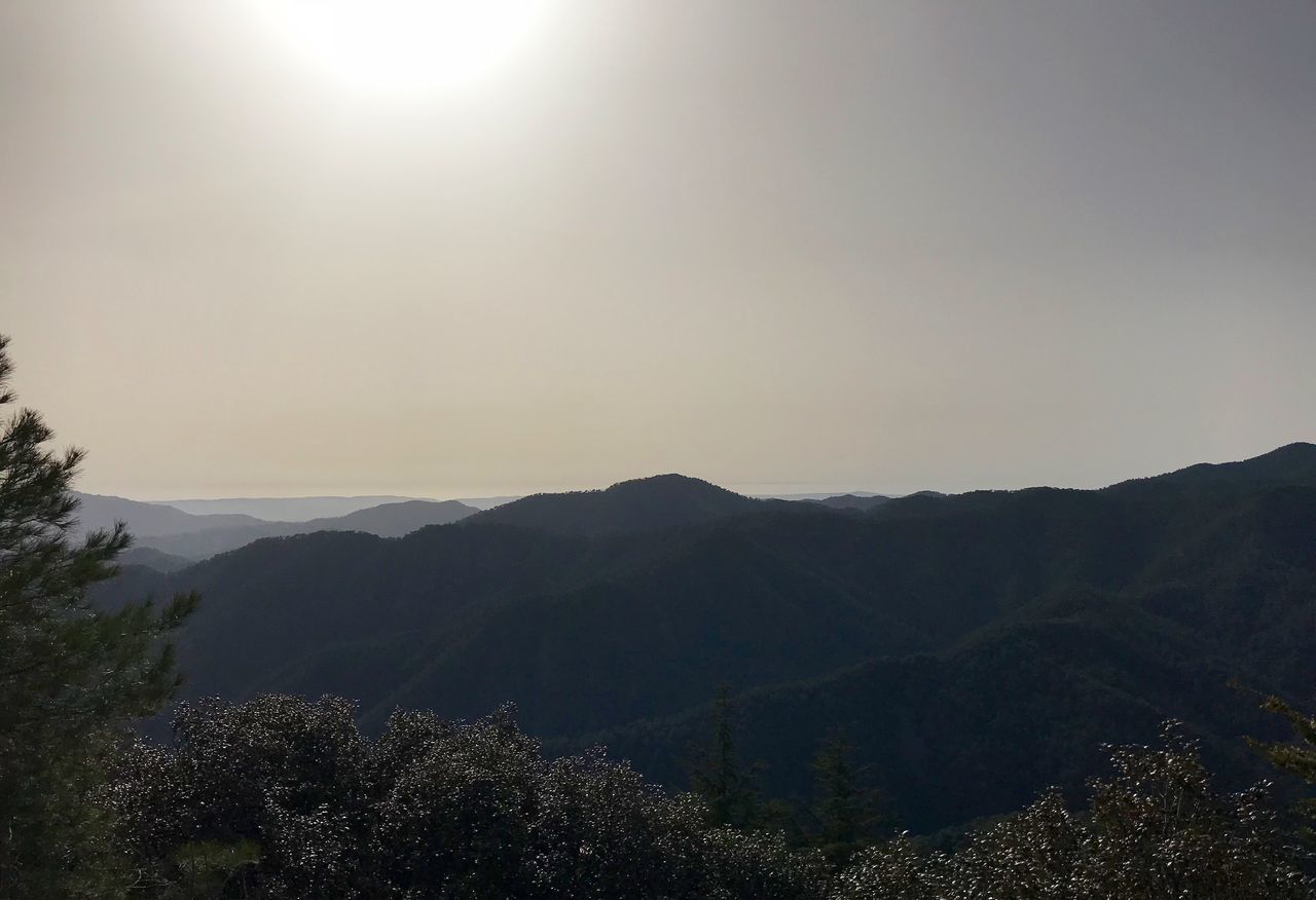 SCENIC VIEW OF MOUNTAINS AGAINST BRIGHT SKY