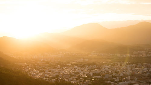 Aerial view of townscape against sky during sunset