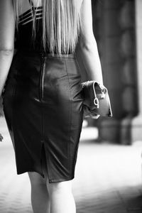 Rear view of woman walking in corridor of building