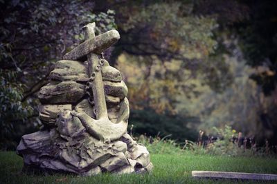 Close-up of statue against stone wall