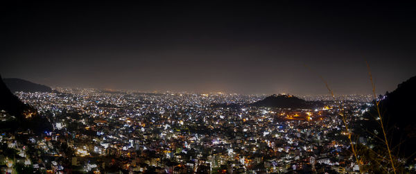 High angle view of illuminated city buildings at night