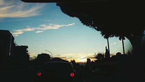 Silhouette city against sky during sunset