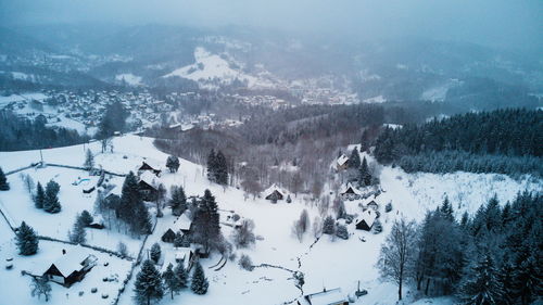 Aerial view of snow covered mountains against sky