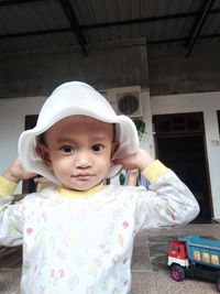 Portrait of cute baby girl standing outdoors