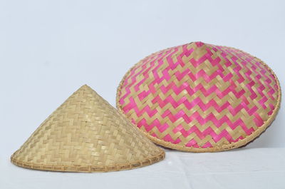 Close-up of wicker basket on table against white background