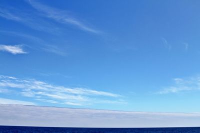 Low angle view of sea against blue sky