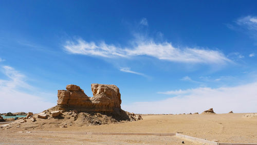 Rock formations on landscape against sky