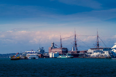 Sailboats in sea against sky