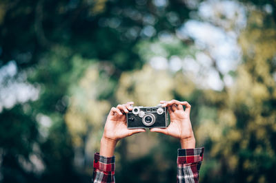 Man photographing against blurred background