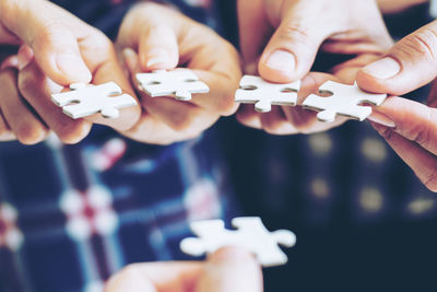 High angle view of hands holding people