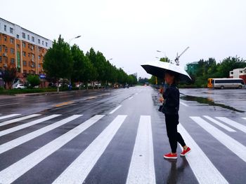 Woman on road against clear sky