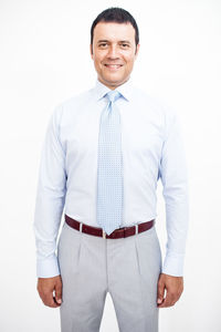 Portrait of smiling man standing against white background