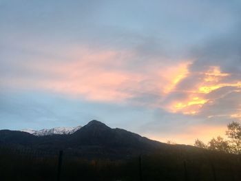 Scenic view of silhouette mountains against sky at sunset