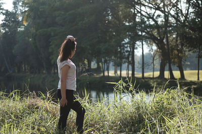 Woman standing against lake