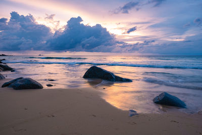 Scenic view of beach against sky during sunset