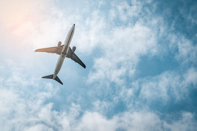 Low angle view of airplane flying in sky