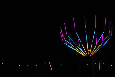 Low angle view of illuminated lights against sky at night