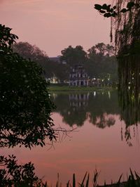 Scenic view of lake against sky at sunset