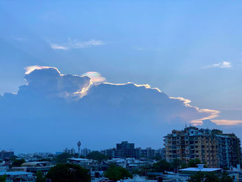 Aerial view of buildings in city against sky