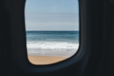 Scenic view of sea seen through window