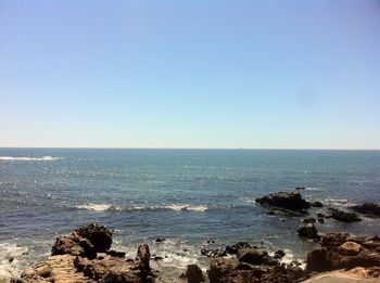 Scenic view of sea against clear blue sky