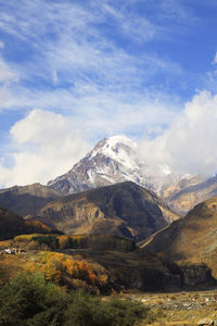 Scenic view of mountains against cloudy sky