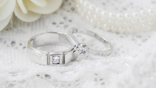 Close-up of wedding rings on table