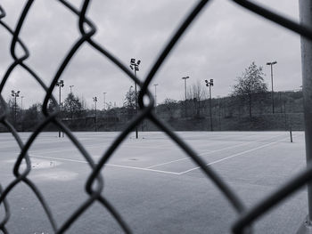 Tennis court seen through chainlink fence