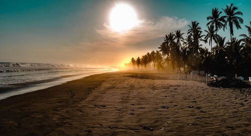 Scenic view of beach against sky during sunset