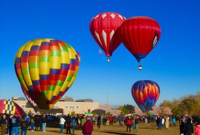 Hot air balloons flying against blue sky