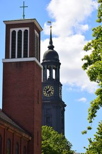 Low angle view of clock tower against sky