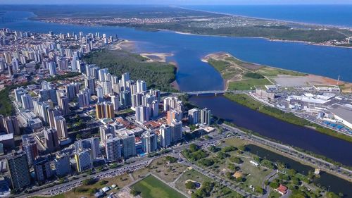 High angle view of buildings by sea against sky