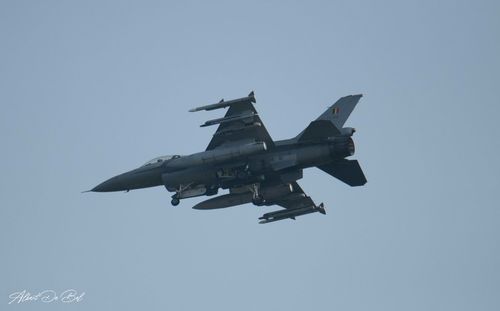 Low angle view of airplane flying against clear sky