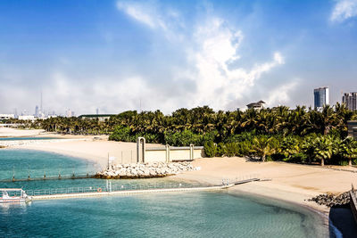 Scenic view of swimming pool by sea against sky