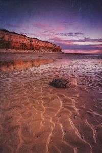 Scenic view of beach against sky during sunset