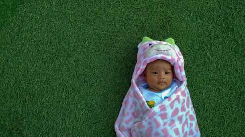 Directly above shot of baby girl lying carpet