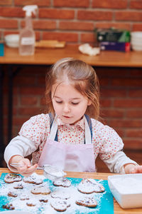 Portrait of a girl with ice cream on table