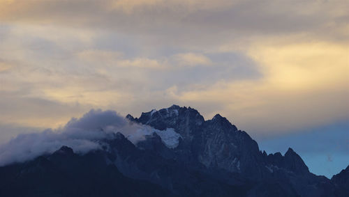 Scenic view of snowcapped mountains against sky during sunset