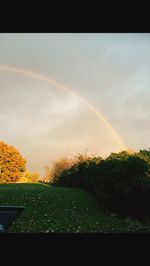 Scenic view of rainbow over field