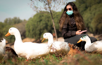 Duck and young woman near of the park lake