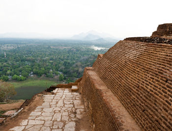 View of buildings on mountain against sky