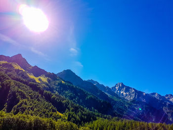 Scenic view of mountain range against blue sky