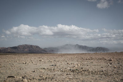 Scenic view of mountains against cloudy sky